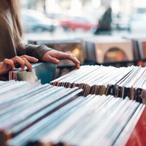 Woman hands choosing vinyl record in music record shop